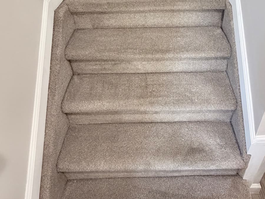 Same taupe carpeted staircase with the dark traffic lanes lifted and the pile looking even after Stain Steamer cleaning