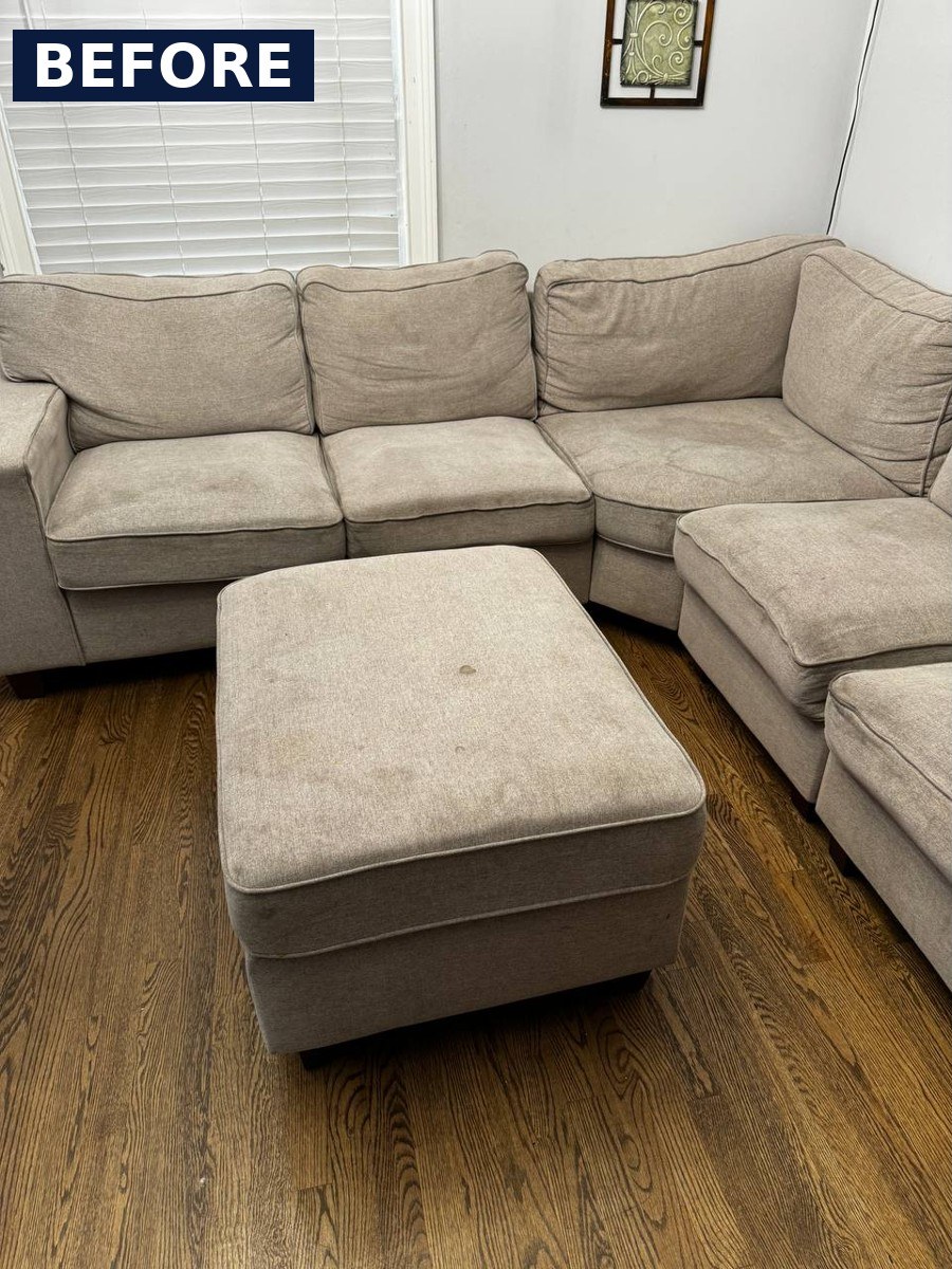Sectional sofa and matching ottoman before cleaning, with darker seat cushions and a visible spot on the ottoman