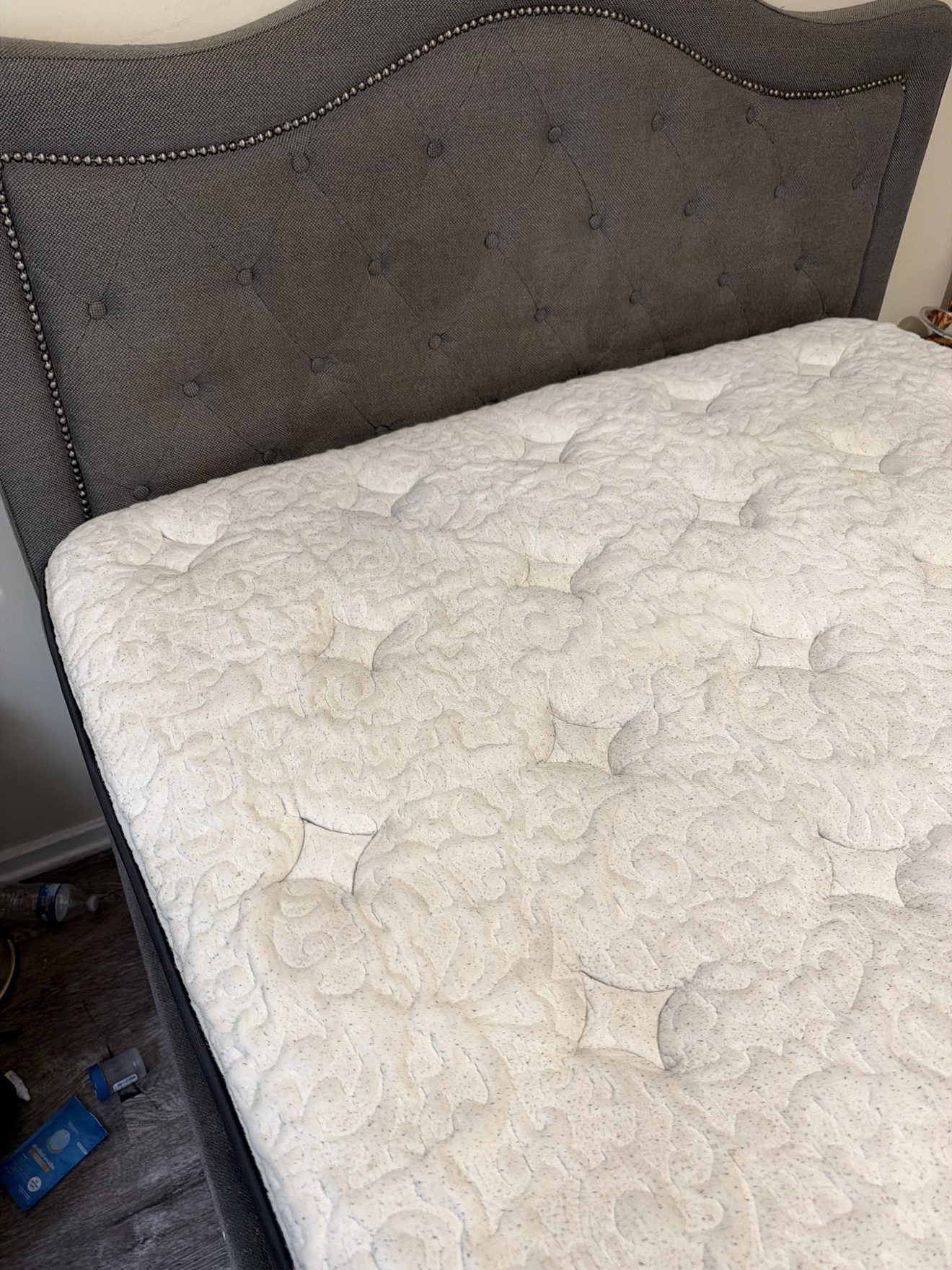 Same white mattress with visible marks reduced after Stain Steamer cleaning