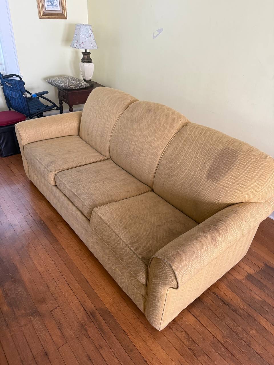 Tan sofa with dark shading on the seat cushions and back before cleaning