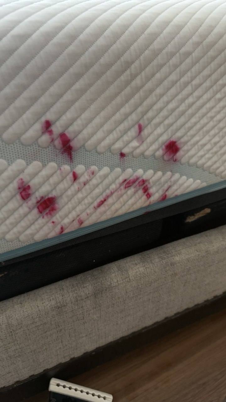White mattress with red spill stains before mattress stain removal
