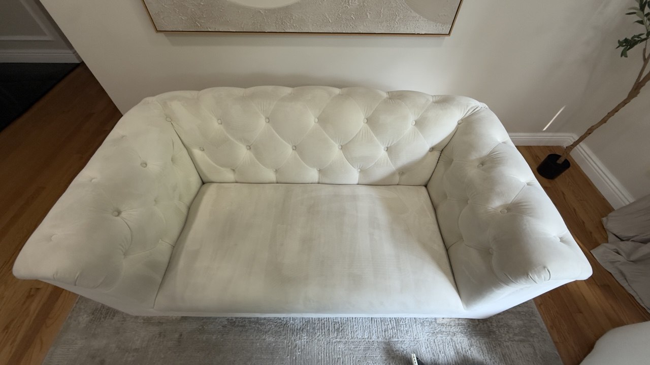 The same white sofa after cleaning, bright and spotless
